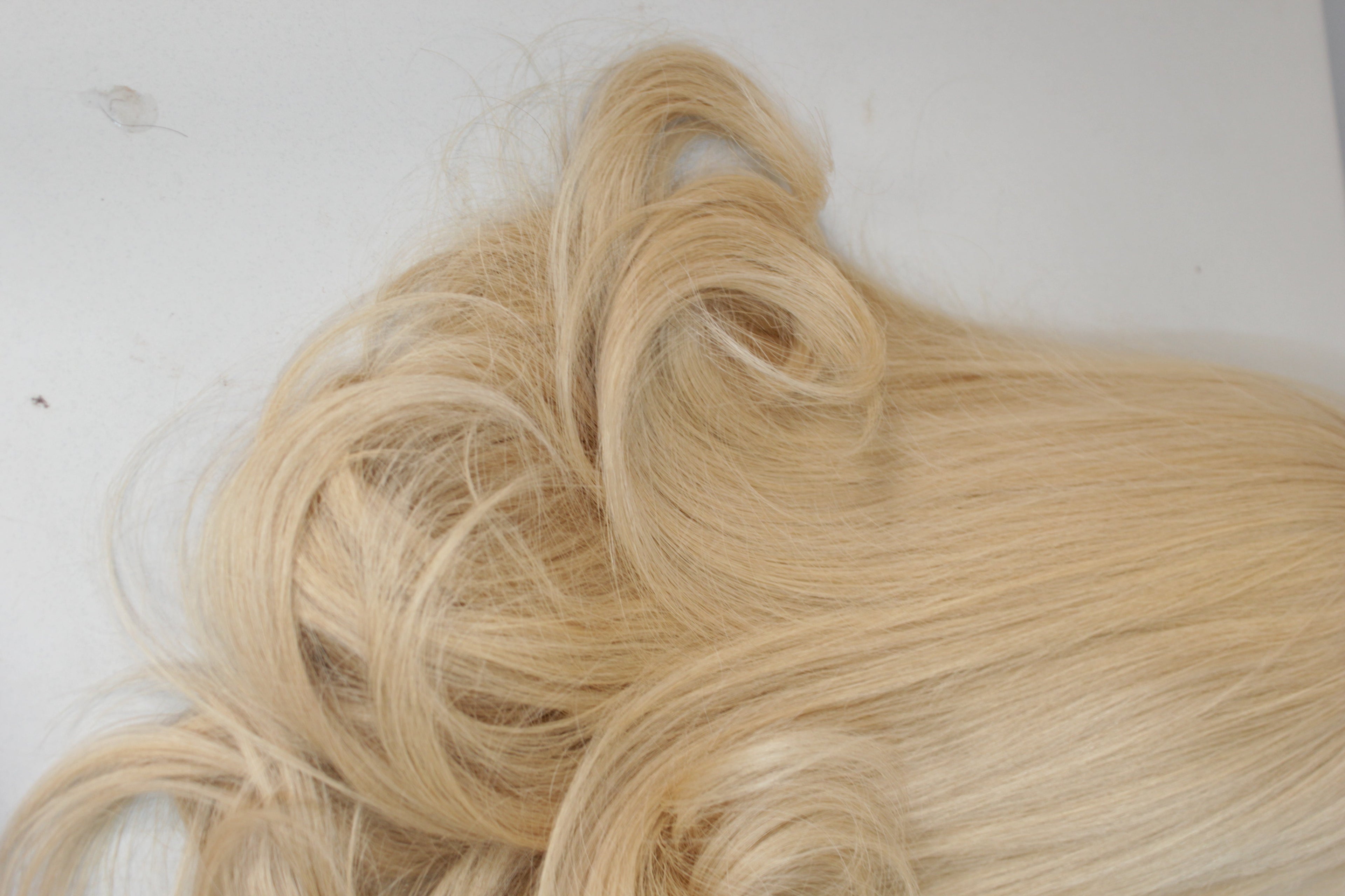 Blonde hair extensions on a white background